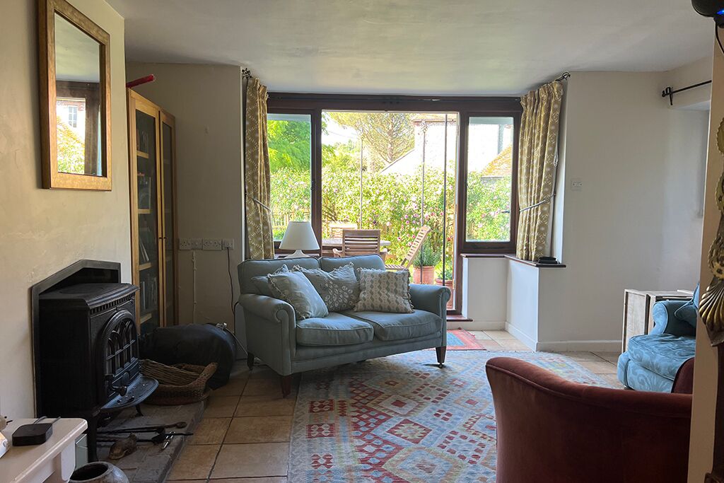 Blue sofas in the living room, with doors opening to the garden